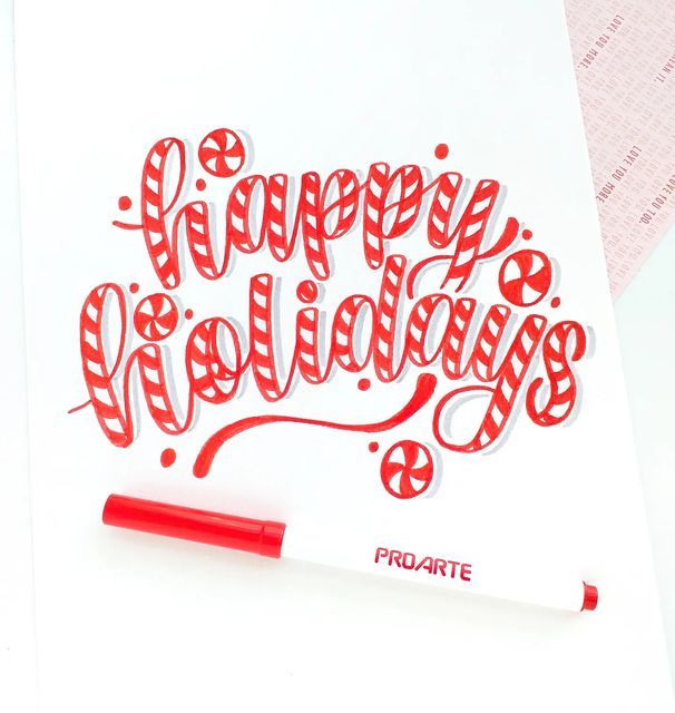 a red and white greeting card with the words happy holidays written in cursive writing