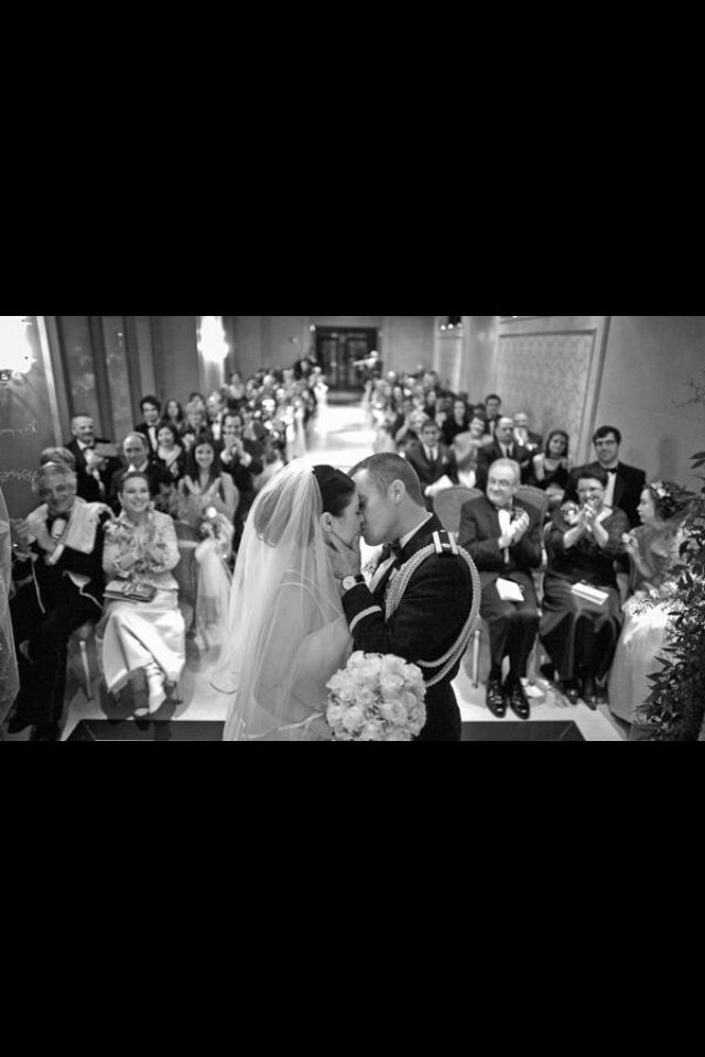 a bride and groom kissing in front of an audience