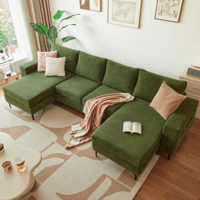 a living room with a large green couch