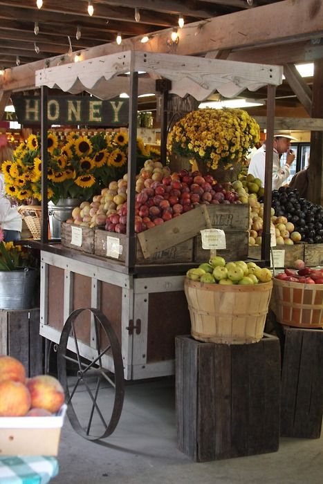 an outdoor fruit stand with lots of fresh fruits and vegetables on display for sale at the market