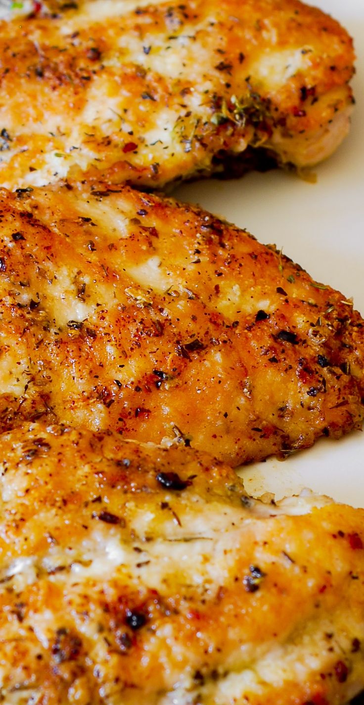 two pieces of chicken on a white plate