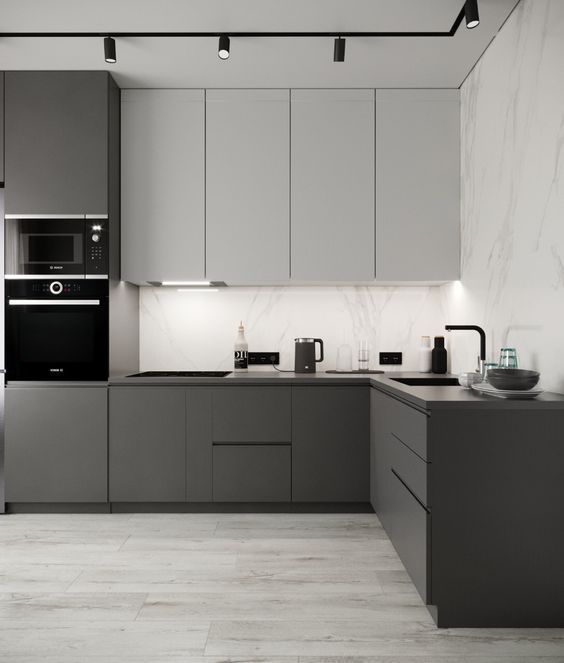 a modern kitchen with marble counter tops and stainless steel appliances, along with gray cabinets