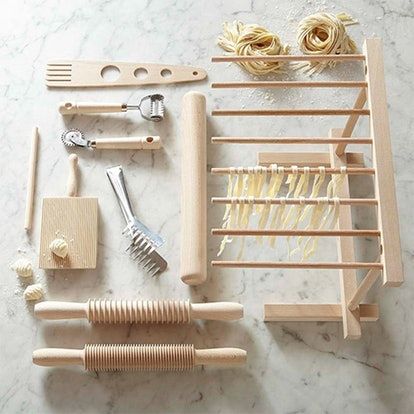 the tools needed to make pasta are laid out on the table