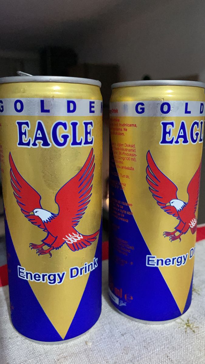 two cans of eagle energy drink sitting on a table