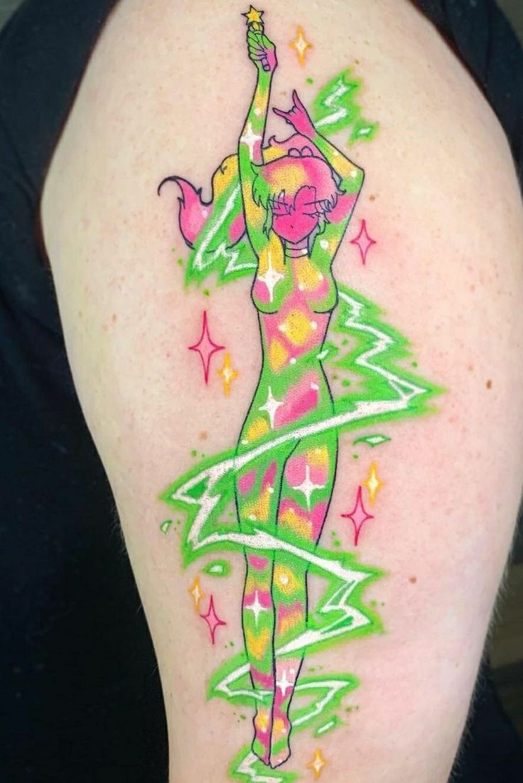 a woman's arm with a green and pink christmas tree tattoo on her left shoulder