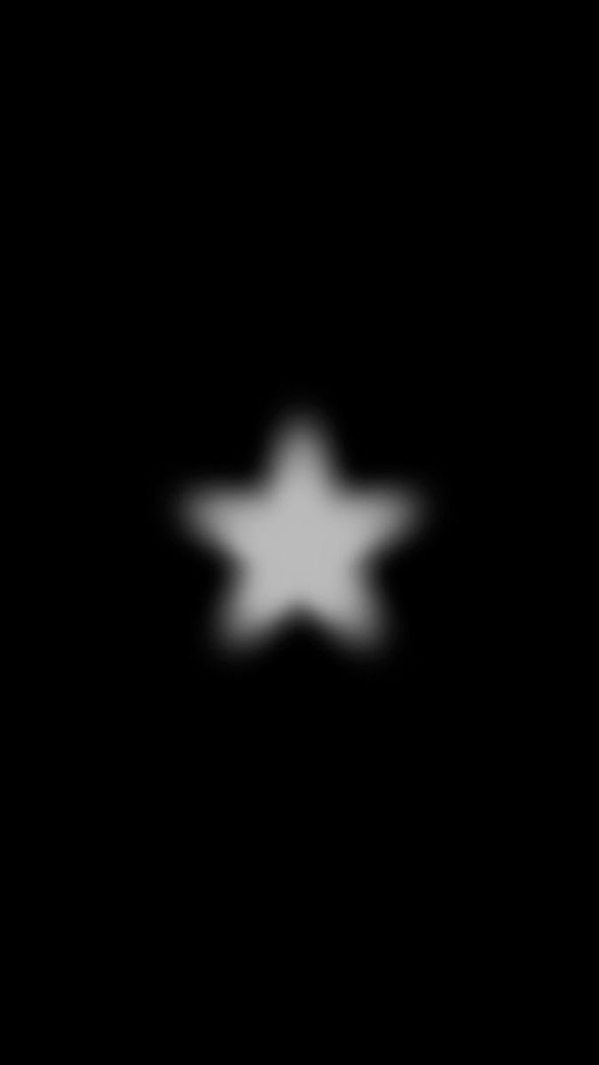 a black background with white stars in the middle and one light shining down on it