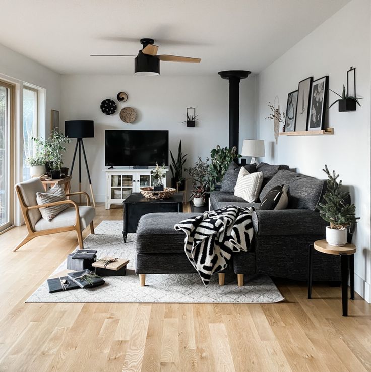 a living room filled with furniture and a flat screen tv on top of a wooden floor