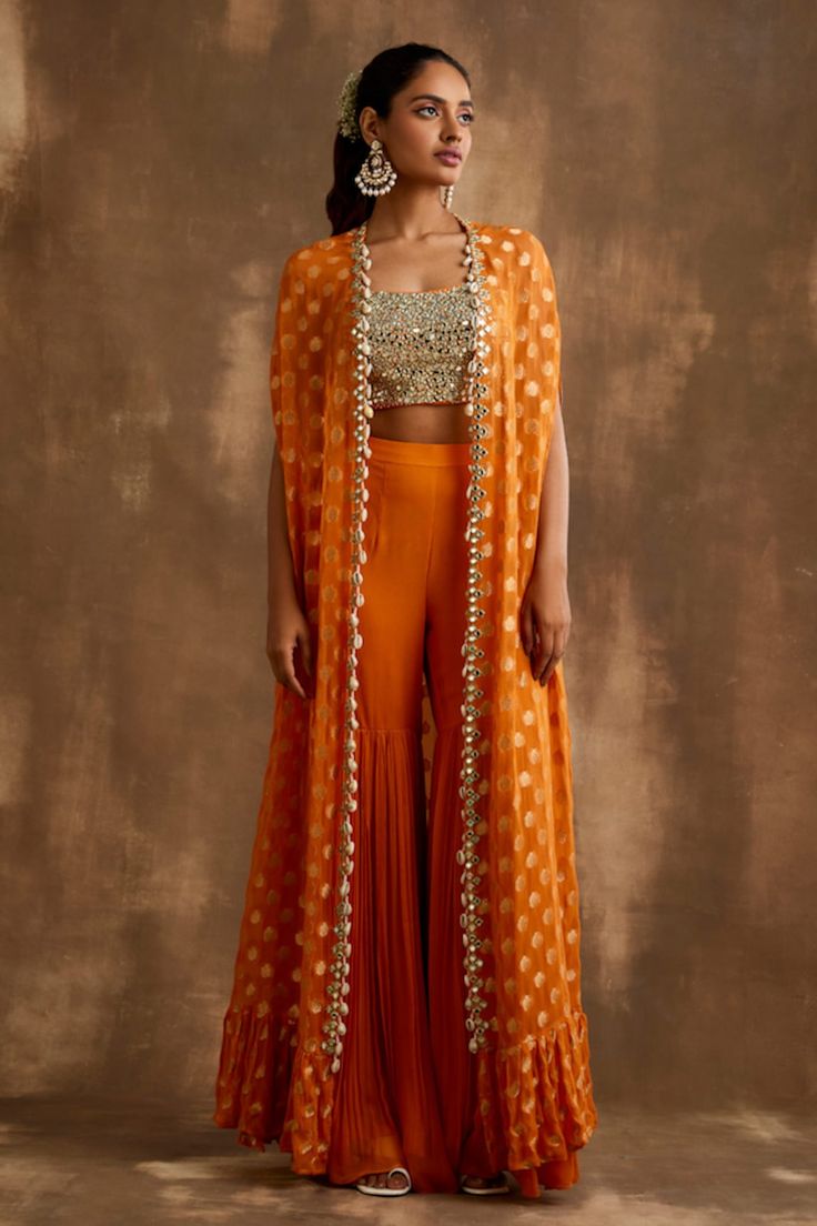 Buy Blue Cape Georgette Skirt Modal Satin Bustier Dupion Ruffle And Set For Women by Aariyana Couture Online at Aza Fashions. Orange Indian Lehenga, Orange Indo Western Outfits, Cape Indian Outfit, Indian Cape Outfits, Orange Traditional Outfits, Indo Western Sangeet Outfit For Women, Haldi Indowestern Outfit, Orange Haldi Outfit, Indian Haldi Outfit