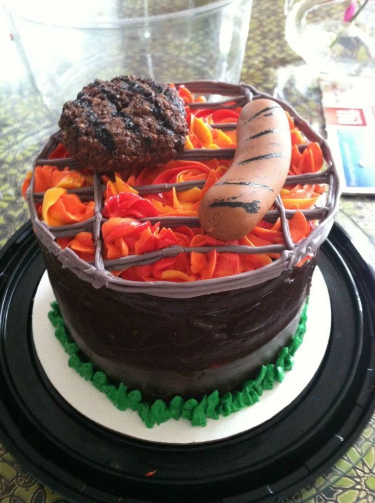 there is a chocolate cake with carrots and a hot dog on the grill in it