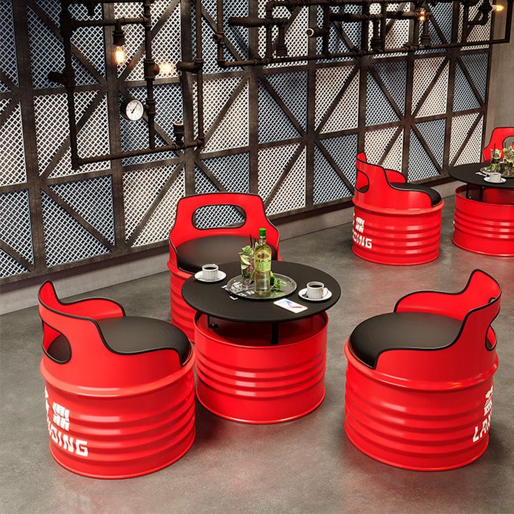 red chairs and tables with black seats in a room