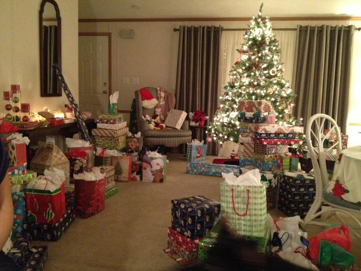 a living room filled with presents under a christmas tree