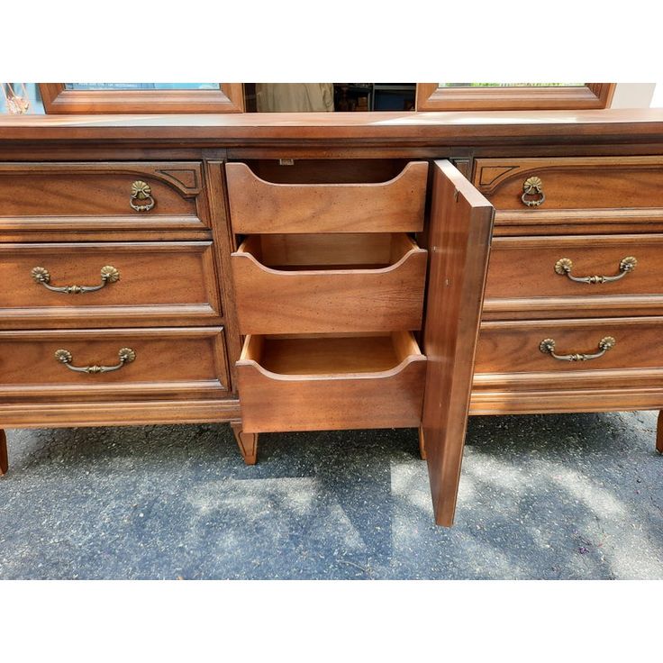 a wooden dresser with drawers on top of it