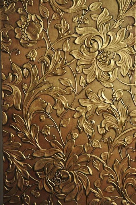 an intricately designed metal surface with gold flowers