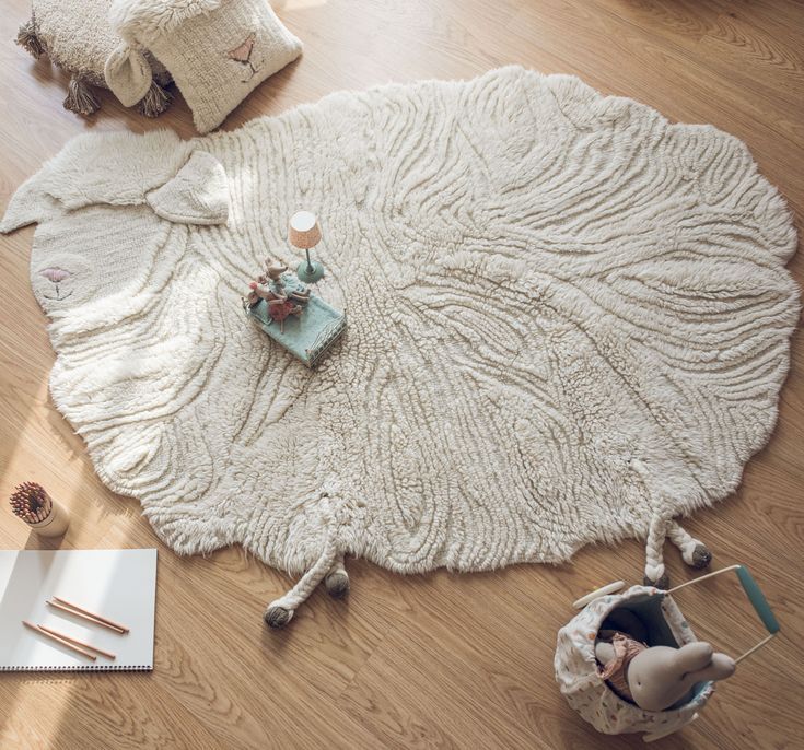 a white rug on the floor with various items around it