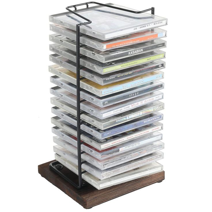 a stack of cds sitting on top of a wooden stand