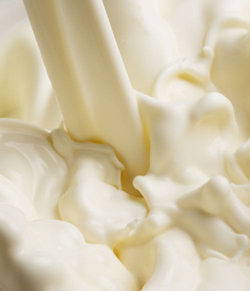 a close up of a milkshake that is being poured into it