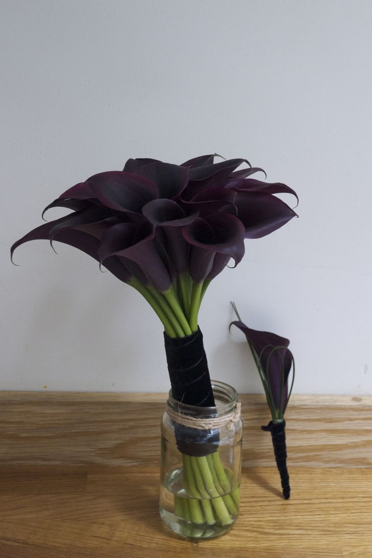 purple flowers in a jar on a wooden table