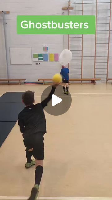 a man is playing with a ball in an indoor gym