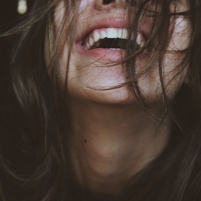 black and white photograph of a woman's face with her hair blowing in the wind