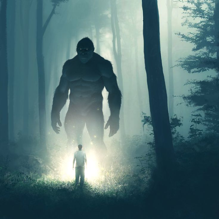 a man standing in the middle of a forest next to a giantfoot with glowing eyes