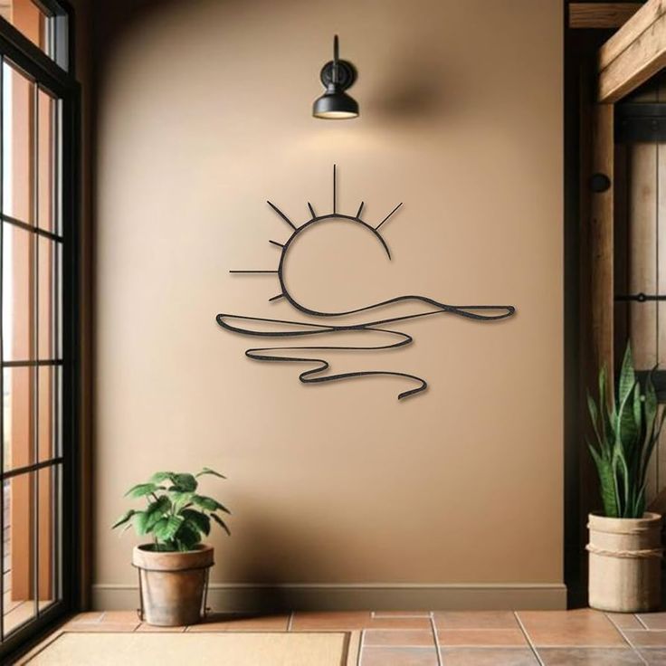 the sun is shining above the water in this wall decal, it's made out of metal