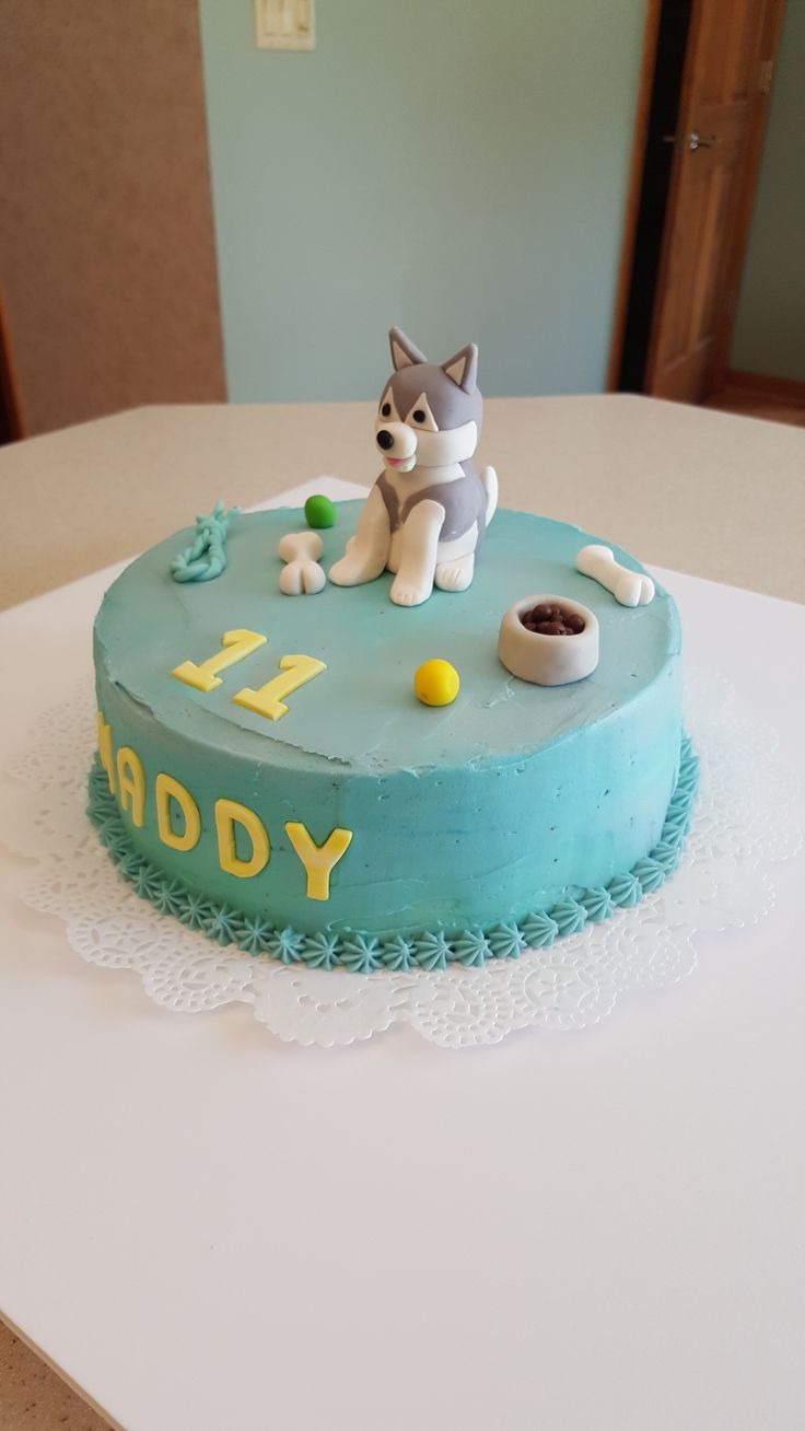 a birthday cake with a dog on top