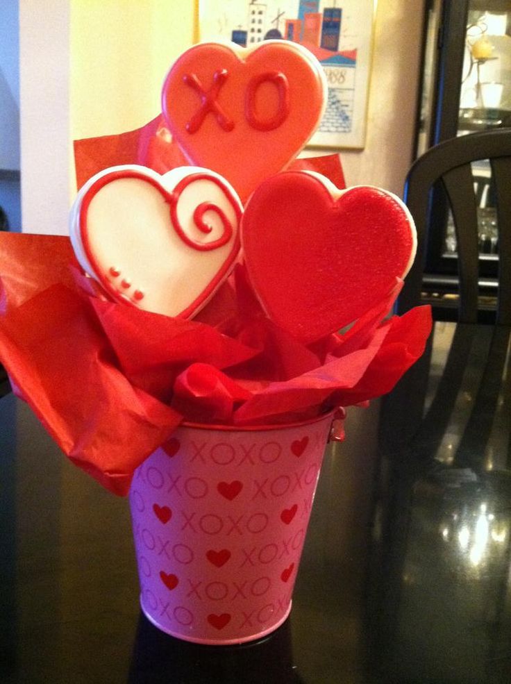 valentine's day decorations in a cup on a table