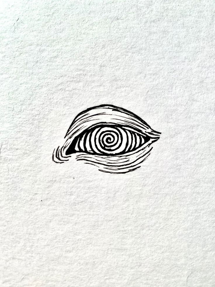 an eye drawn on paper with black ink