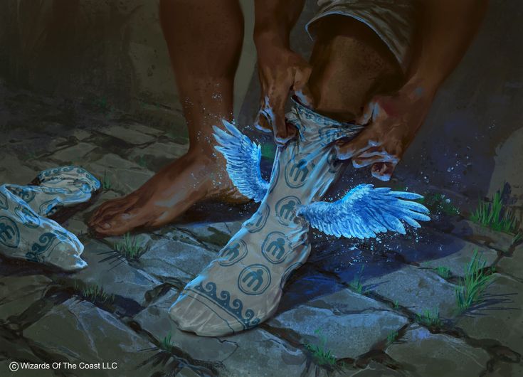 a man is painting his shoes with blue paint on the ground and wings painted on them