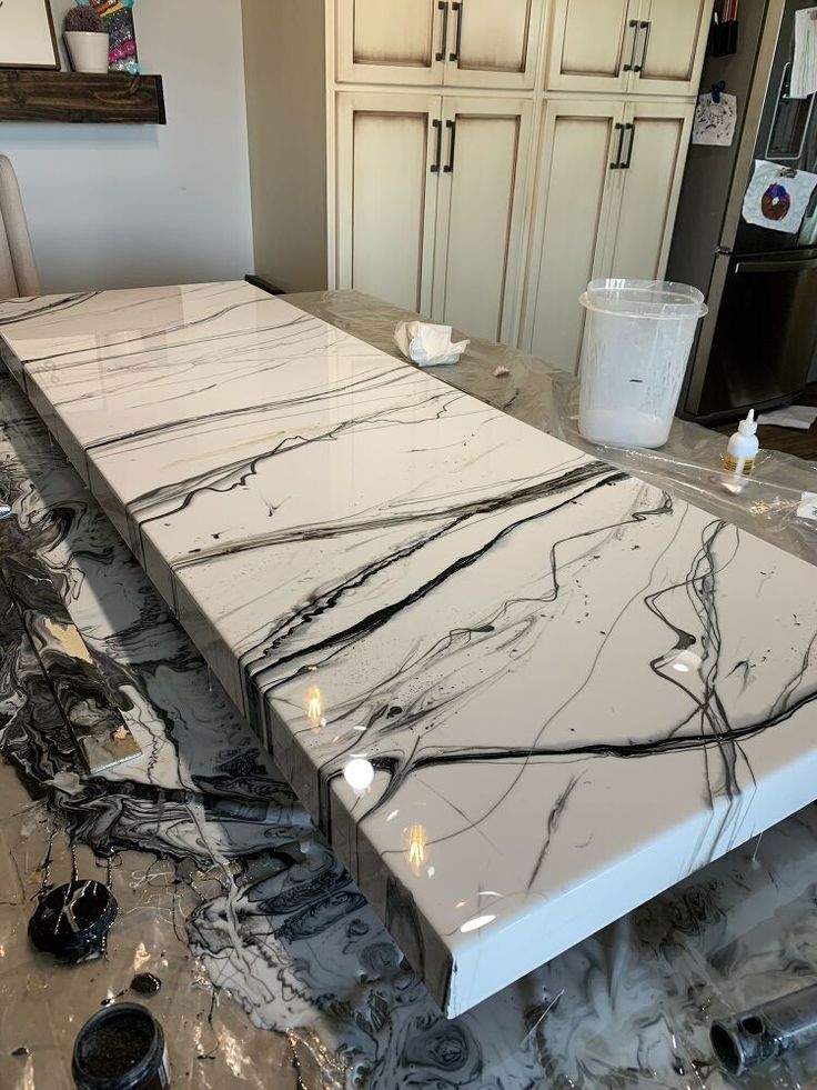 a kitchen counter that has been painted white with black streaks on the top and bottom