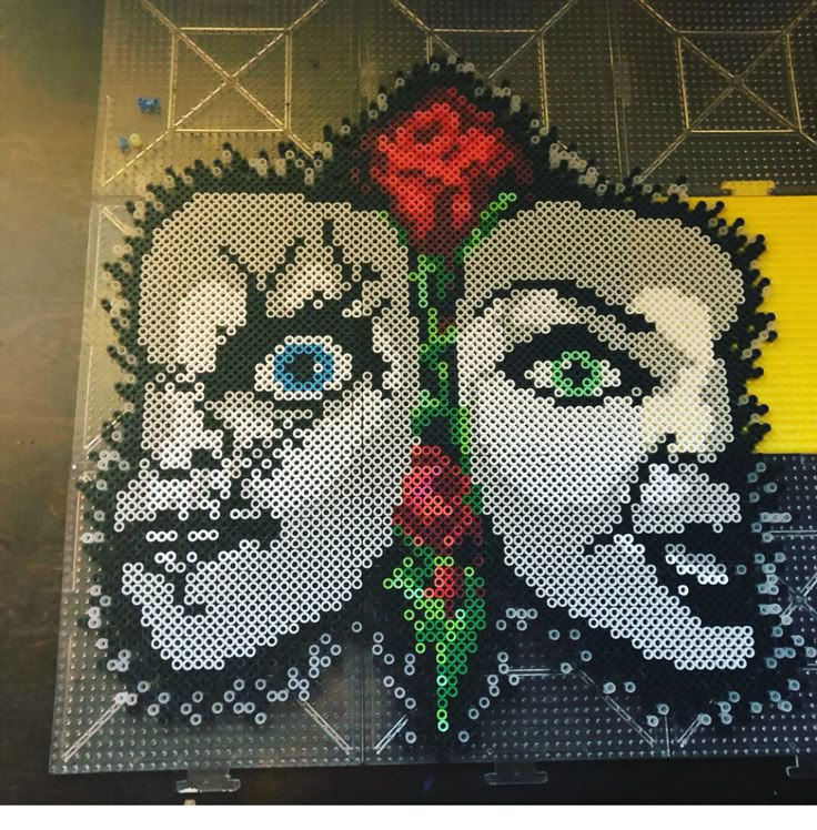 a close up of a piece of art made out of legos with a woman's face painted on it