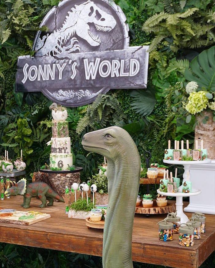 a dinosaur themed birthday party with cake and desserts