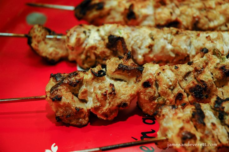 several skewers of food sitting on top of a red tray