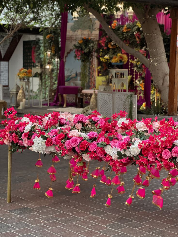 pink and white flowers lined up on a table