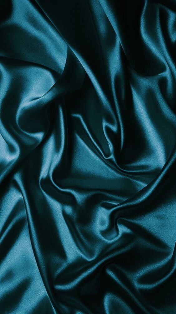 a close up view of a blue satin fabric