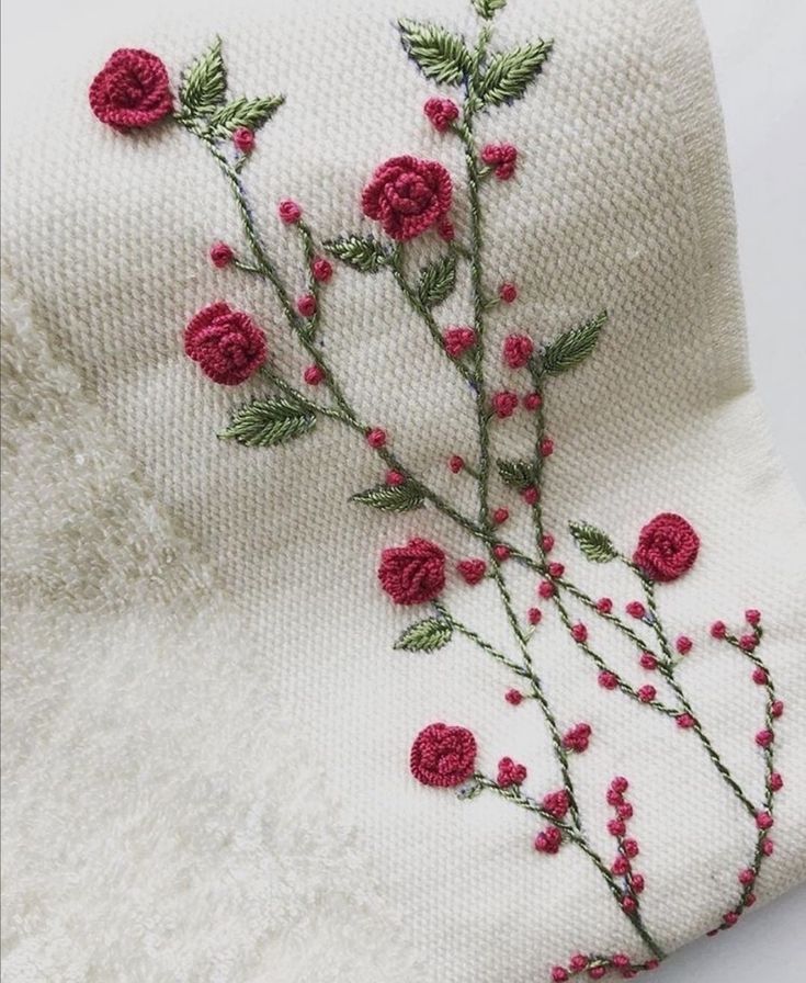 a white towel with red flowers on it