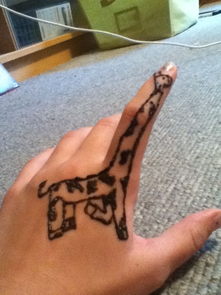 a hand with a giraffe drawn on it