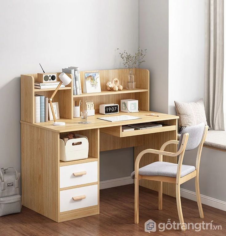 a wooden desk with two drawers and a white chair in front of it, next to a window