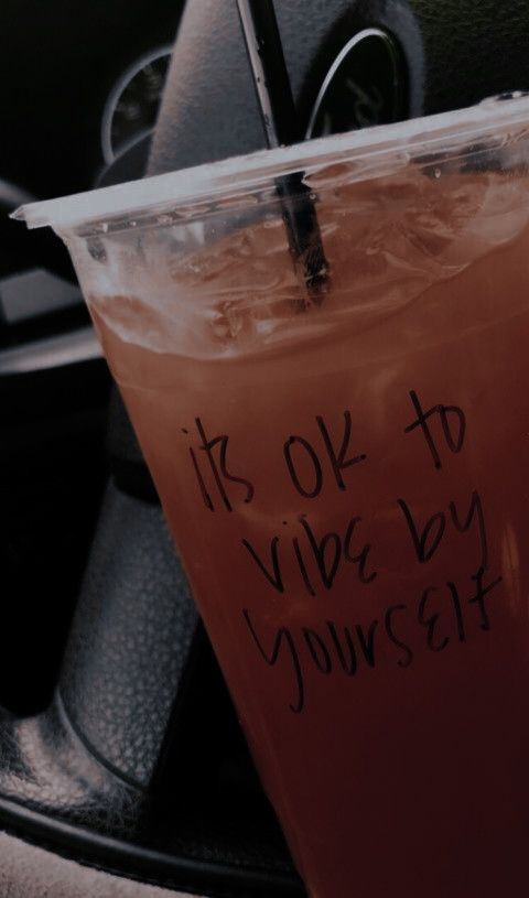 a drink in a plastic cup with writing on it