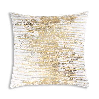 a gold and white pillow on a white background