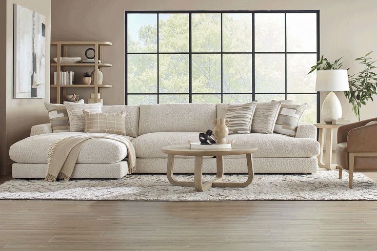 a living room filled with furniture and a large window