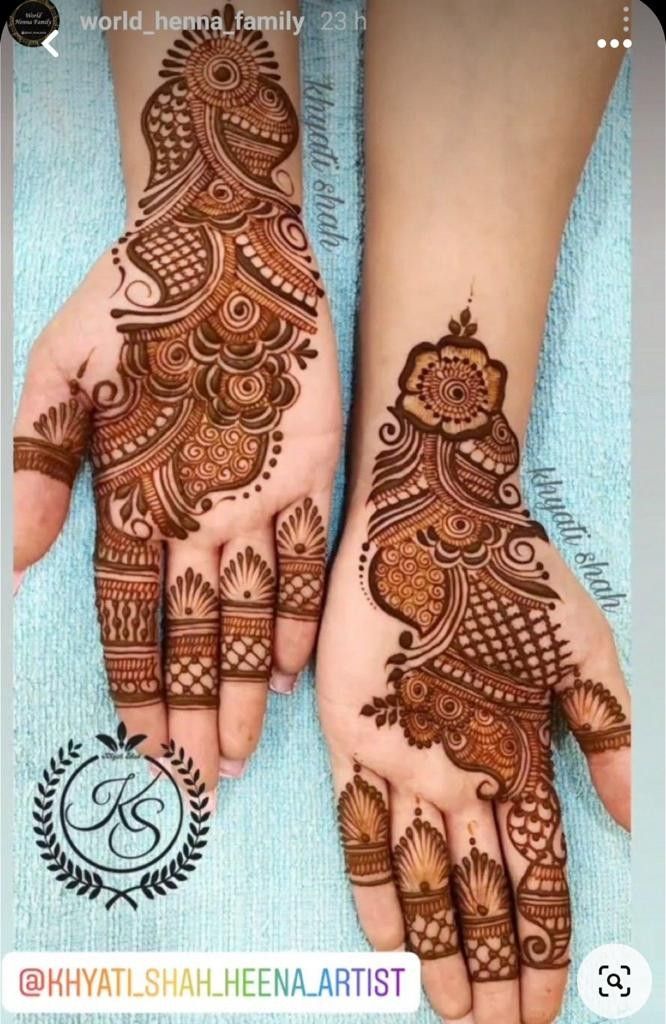 two hands with henna tattoos on them, one is showing the intricate pattern and the other