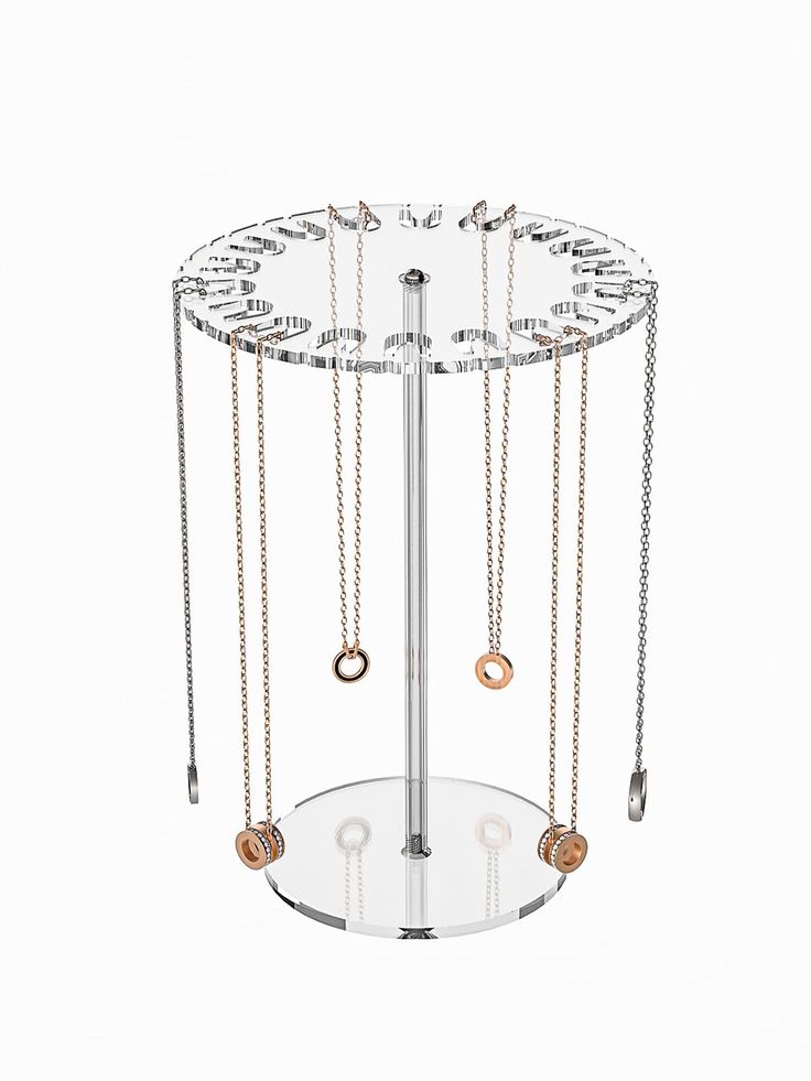 a metal and glass jewelry stand with several necklaces hanging from it's sides