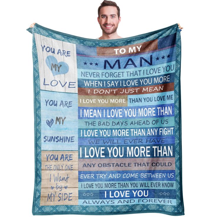 a man is holding up a blanket with the words i love you more on it