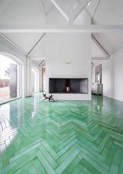 a large room with green flooring and white walls