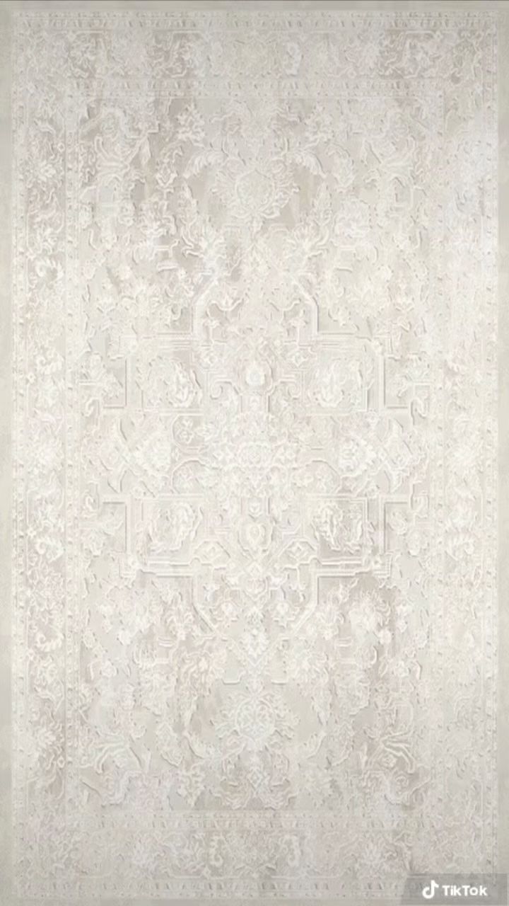 a white rug with an intricate design on it