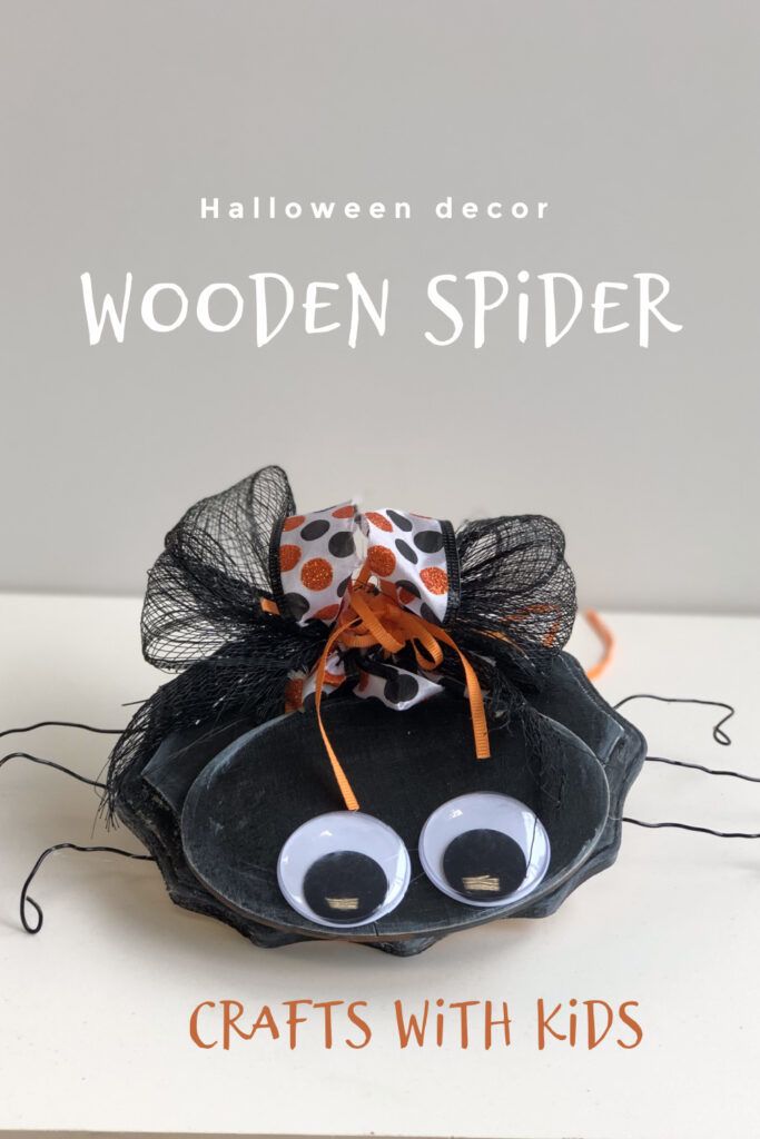 a halloween decoration made out of paper with googly eyes and polka dots on it