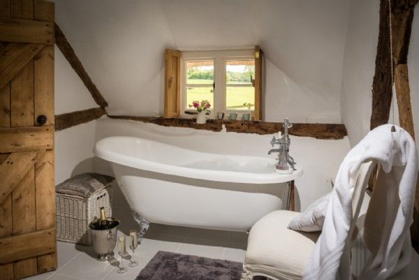 a bathroom with a claw foot tub and white walls