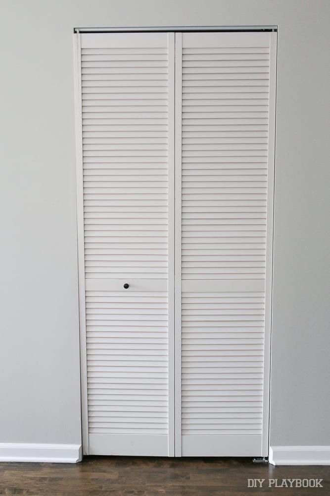 two white closet doors in a room with hardwood floors