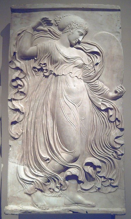 an intricately carved relief depicting a woman with flowing hair